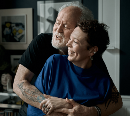 Olivia Colman and John Lithgow in a warm embrace